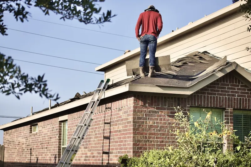 Professional roofer working on a residential roof in Brighton